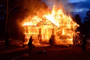 A firefighter fights a house fire