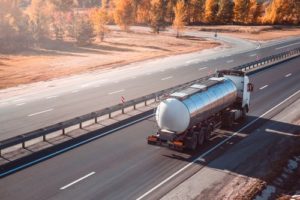 A fuel truck drives on a highway