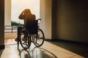 A person sits alone in a wheelchair