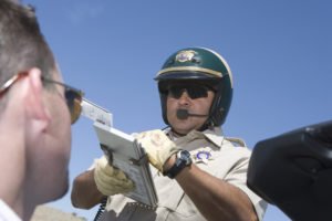 A police officer writing a traffic ticket.