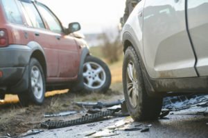 A vehicle accident where one vehicle has a detached tire.