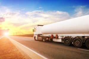 fuel truck driving at sunset