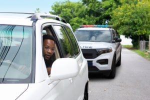 A young man pulled over by police.