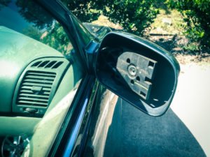 car with broken rearview mirror