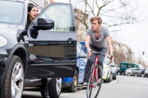 cyclist about to plow into an open car door