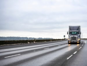 tractor-trailer driving down the highway