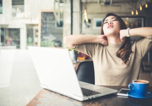 woman with a sore neck at her desk