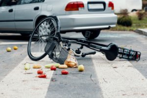 broken bike on pedestrian crossing after collision with car