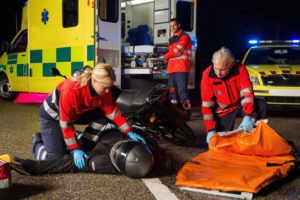 first responders assist an injured motorist after motorcycle accident