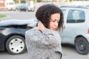 woman experiences neck pain after a car wreck