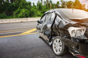 a smashed car on the highway