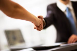 new client shakes hands with attorney