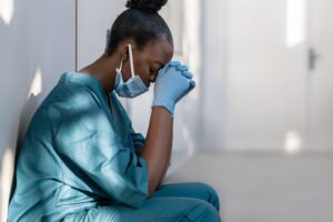 tired nurse sits in the hospital hall